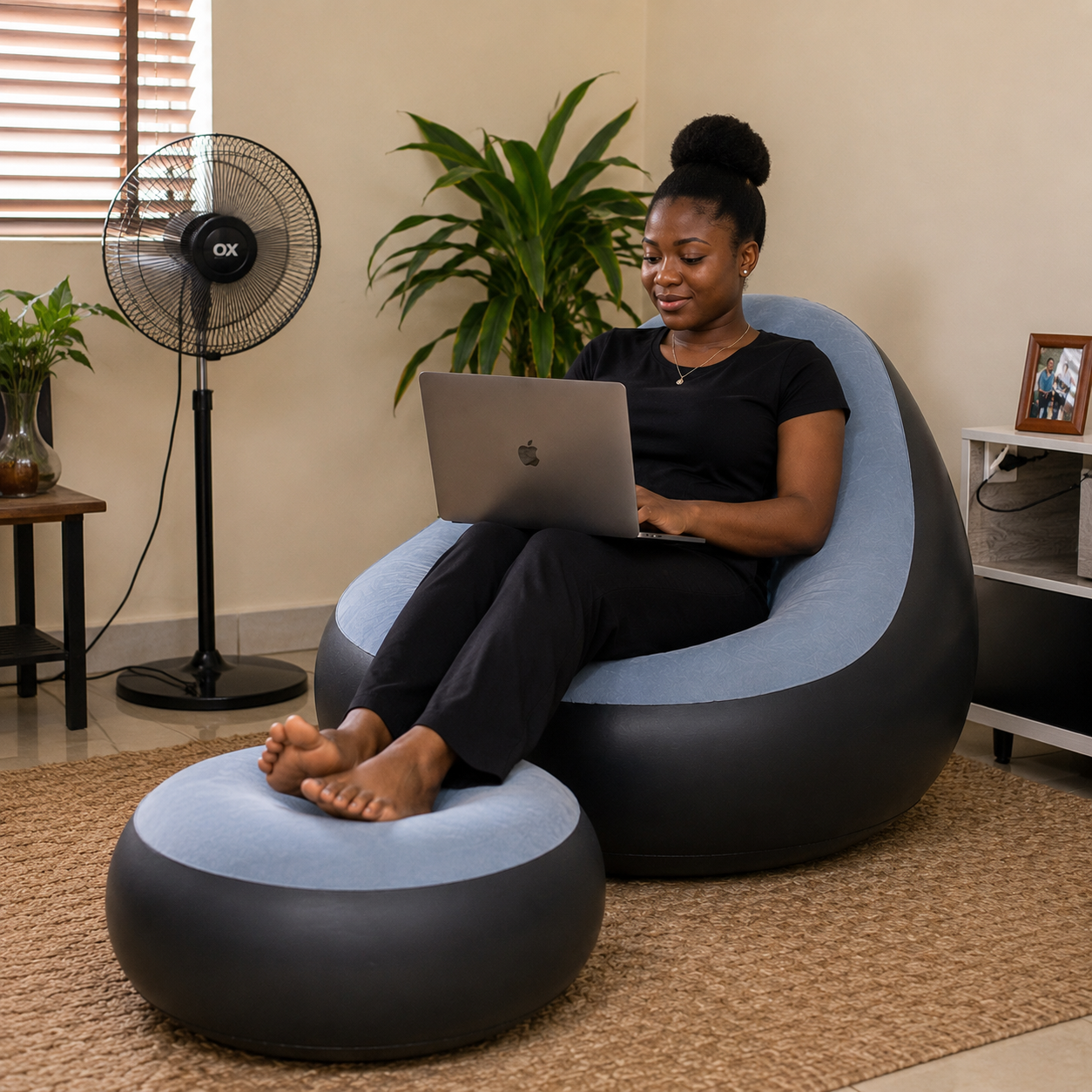Woman working on laptop in blue sofa
